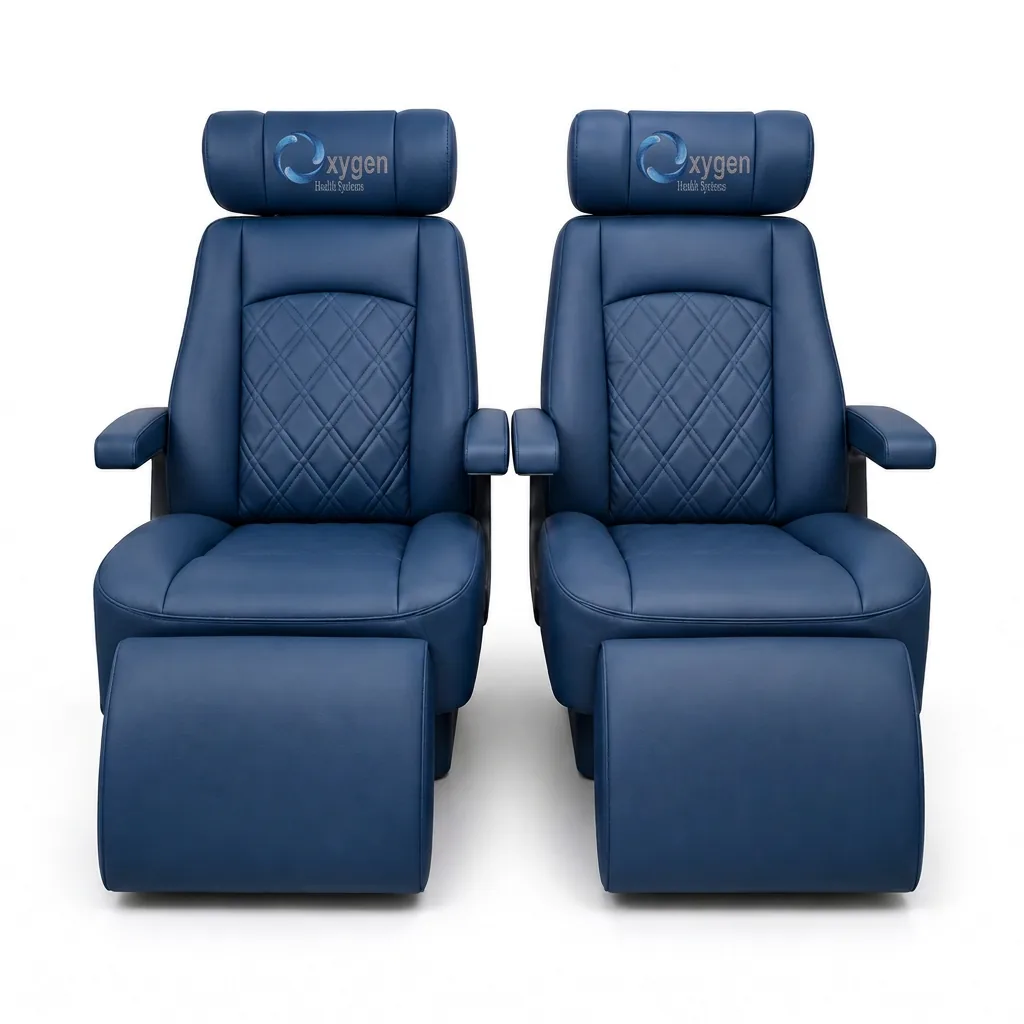 Two navy blue quilted leather captain's chairs with extended footrests and embroidered Oxygen Health Systems headrest logos, shown front-on with diamond-stitched center panels and padded armrests